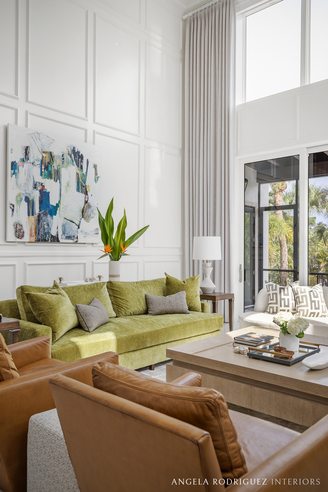 Living room with green sofa and colorful art