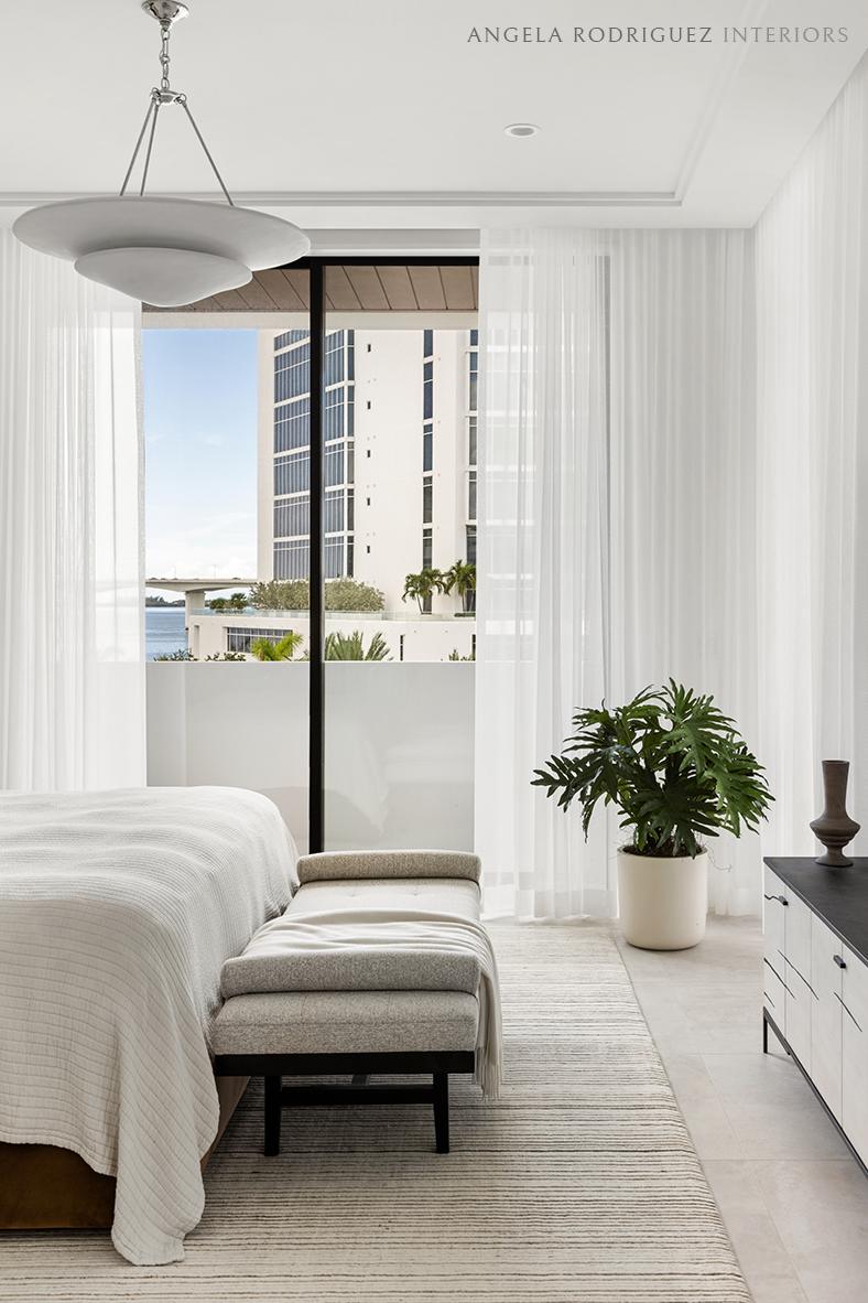 Modern bedroom with white sheers and neutral color palette