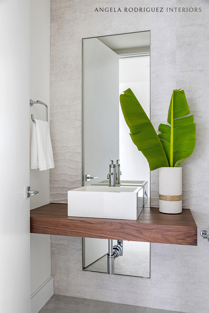 Floating sink vanity with textured wall tile