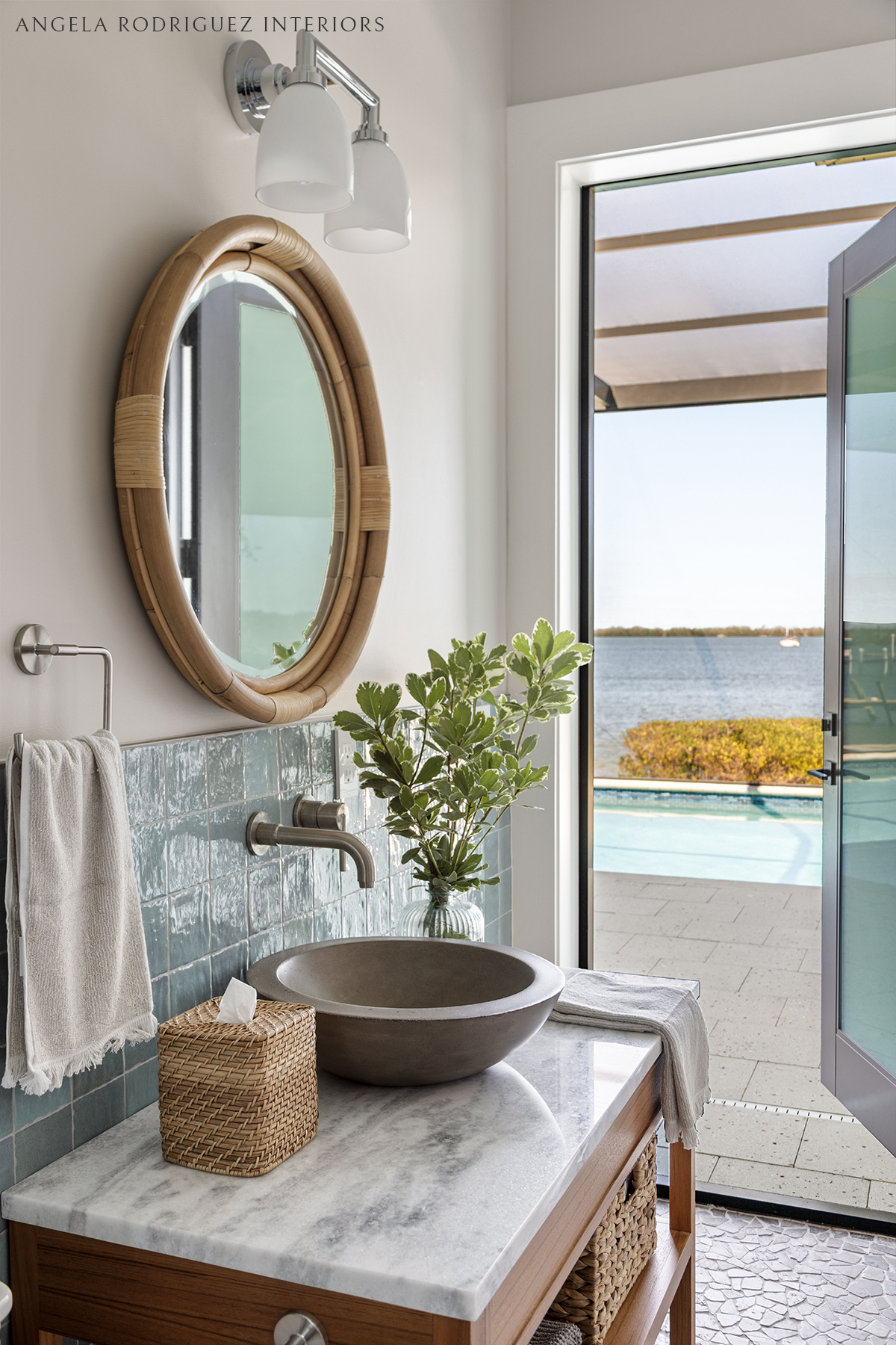 Pool bath with blue tile and round mirror