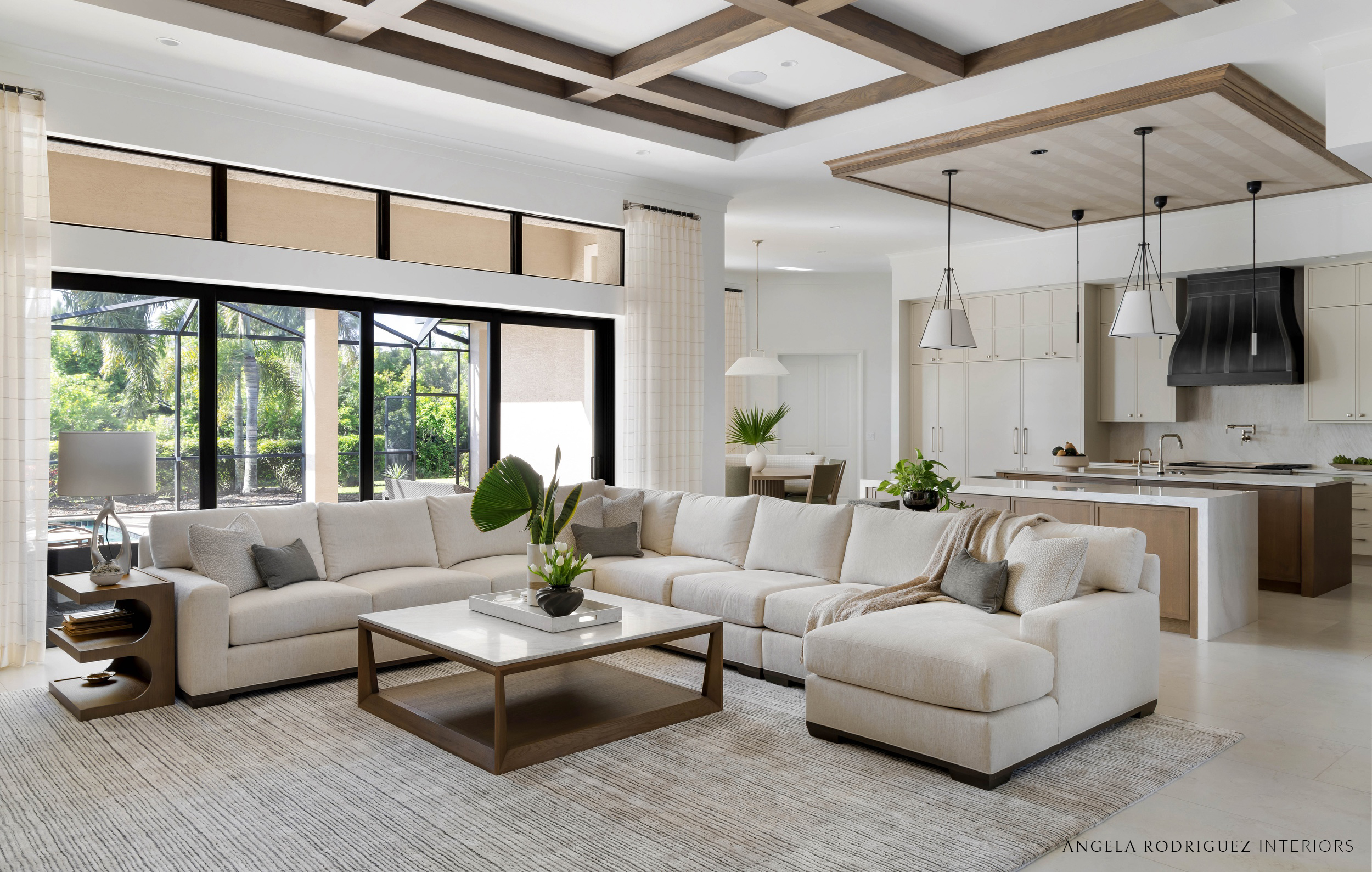 Living room with sectional sofa and custom kitchen beyond