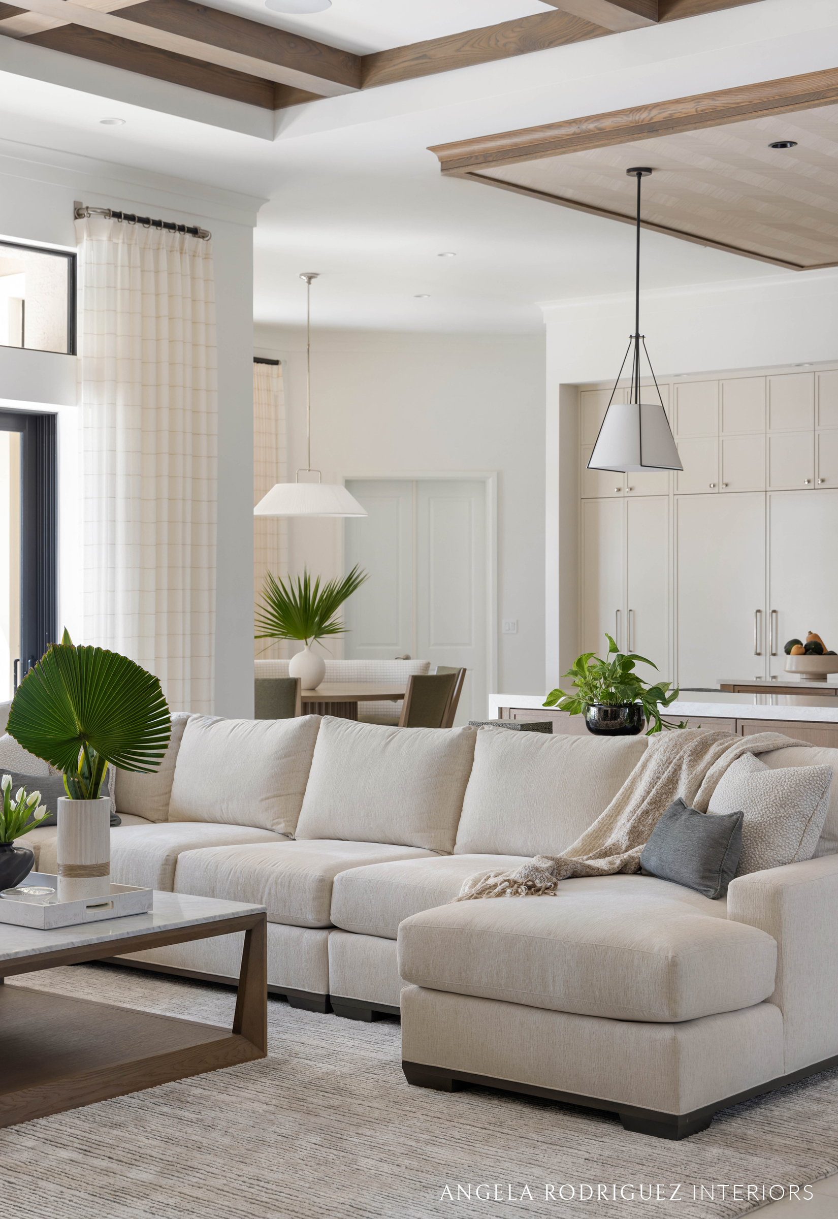 Neutral living room with kitchen beyond