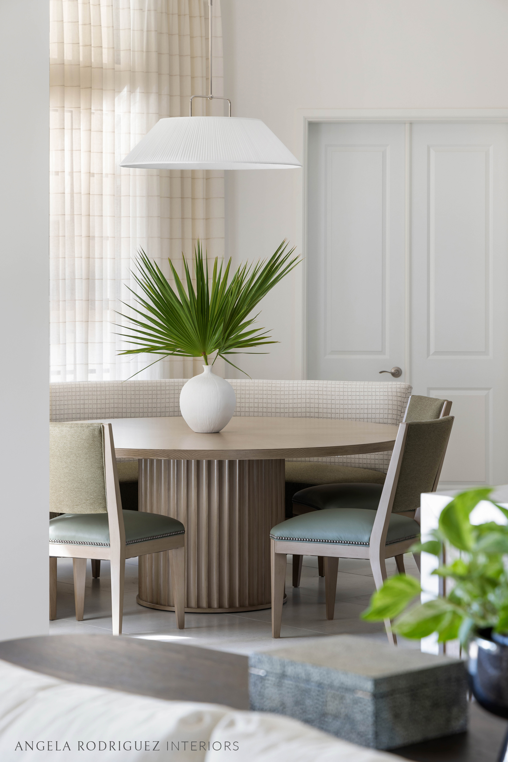 Round dining table with seating and pendant light